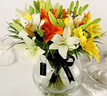 Mix Of Lilies In Fishbowl Vase